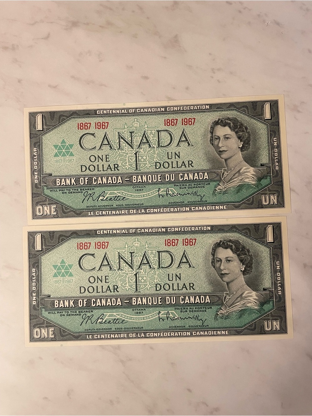 1967 set of 2 - Canada Centennial One Dollar Bills - Green - uncirculated